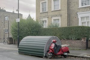 Residential street in London with moped next to bike shed