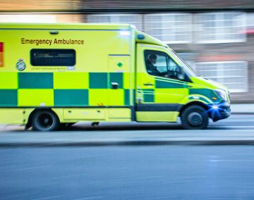 photograph of an ambulance driving fast