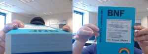 photo of a very thick handbook (side on and front view) that staff need to consult on a daily basis