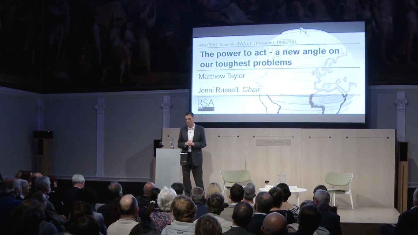 a photo of Matthew Taylor onstage taken from the video 'The Power to Act'